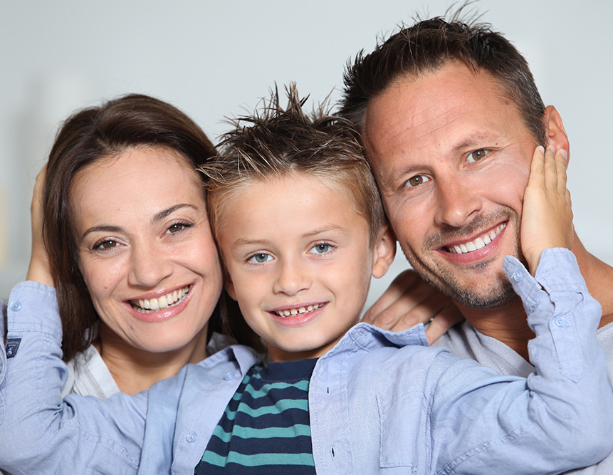 Child posing with mother and father.