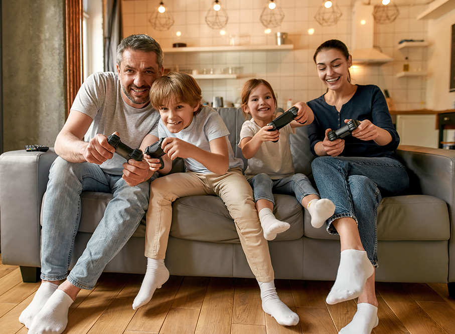 Family on a couch playing video games together.